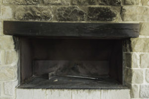 black and sooty fireplace with empty fire box